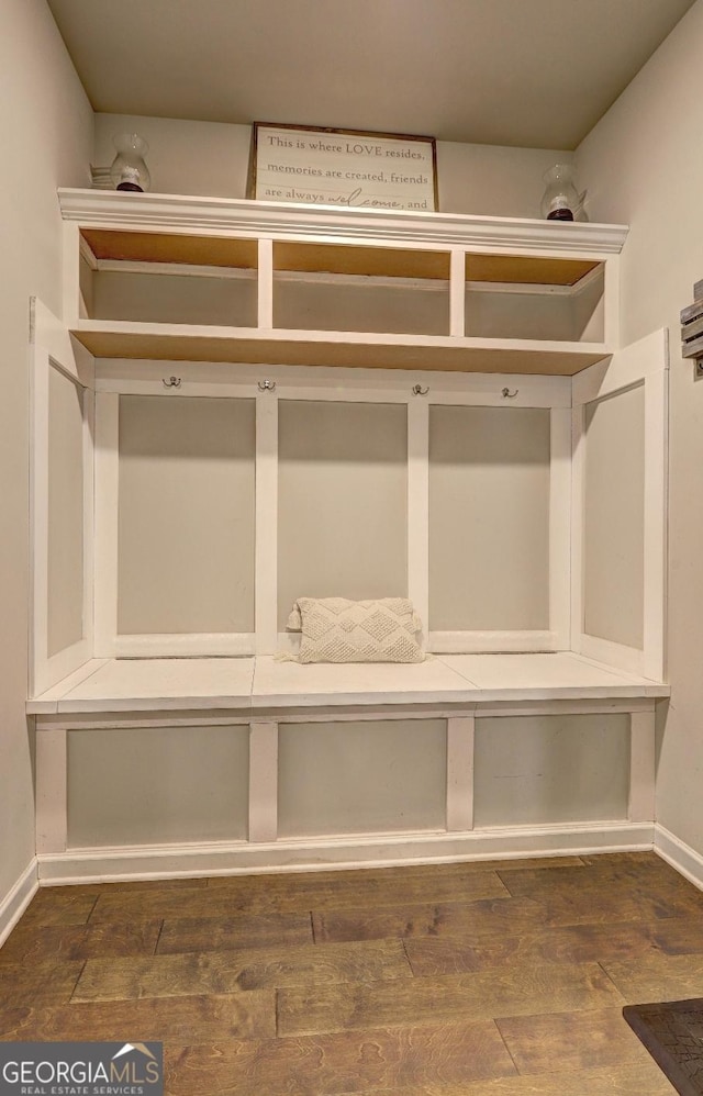 mudroom featuring wood finished floors and baseboards