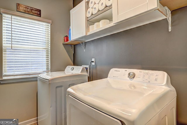 laundry room featuring washing machine and dryer and cabinet space