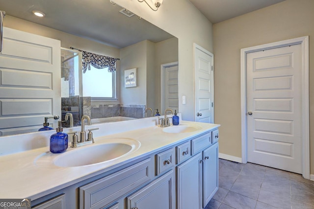 bathroom featuring double vanity, tile patterned flooring, a sink, and a shower stall