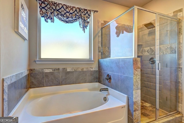 bathroom with a garden tub and a shower stall