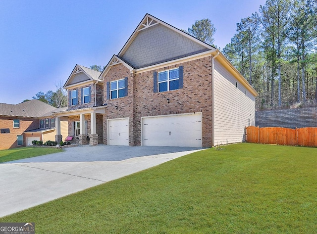 craftsman-style home with brick siding, a front yard, fence, a garage, and driveway