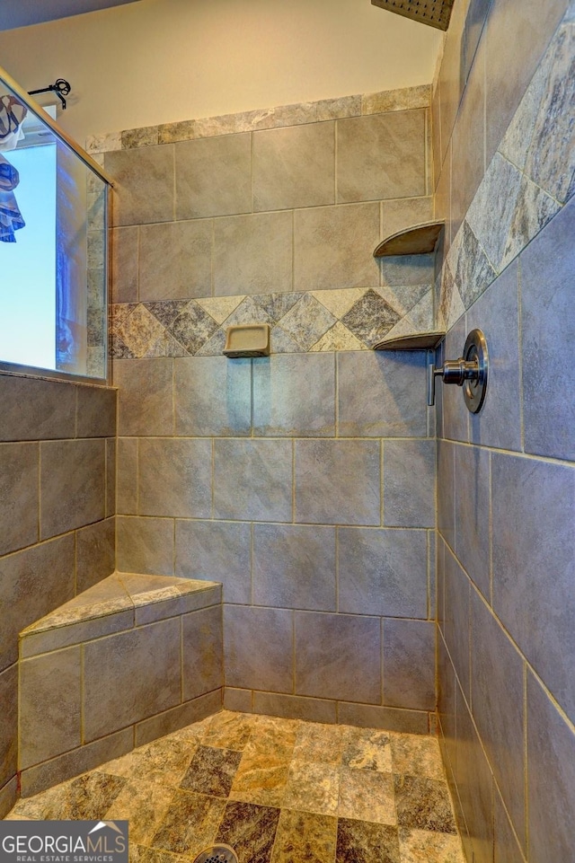 full bath featuring tiled shower