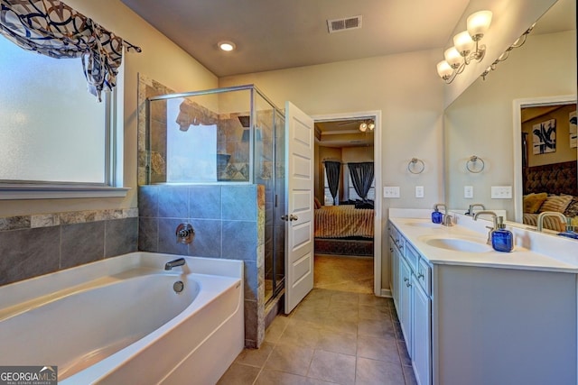 ensuite bathroom with ensuite bathroom, a sink, visible vents, tile patterned floors, and double vanity