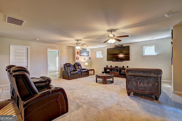 carpeted living room featuring baseboards, visible vents, and ceiling fan