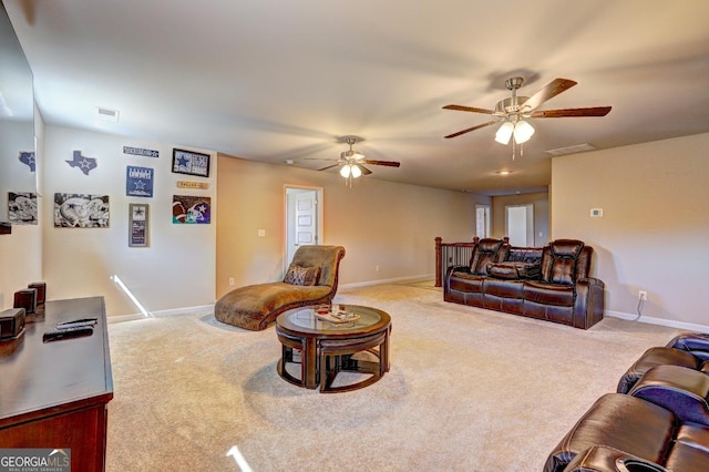 living area with visible vents, carpet floors, a ceiling fan, and baseboards