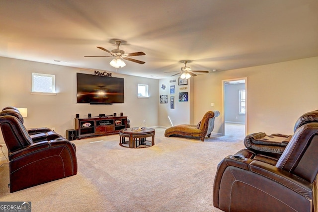 living room with ceiling fan, carpet flooring, and a wealth of natural light