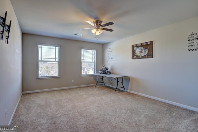 carpeted home office with baseboards, visible vents, and a ceiling fan