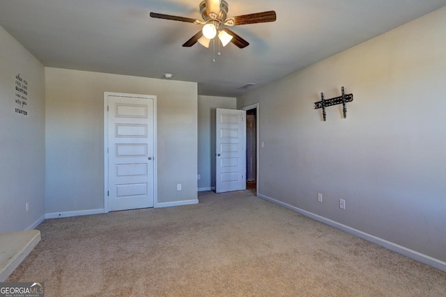 unfurnished bedroom featuring a ceiling fan, baseboards, and carpet flooring