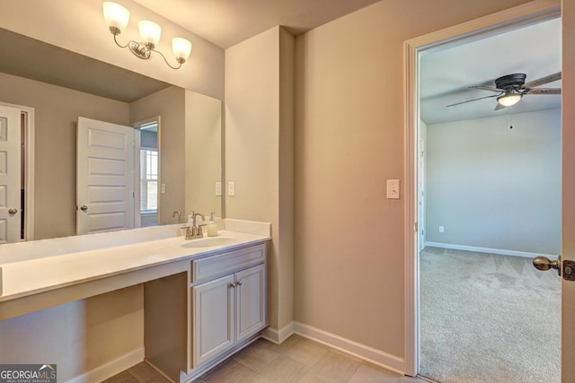 bathroom with a ceiling fan, vanity, and baseboards