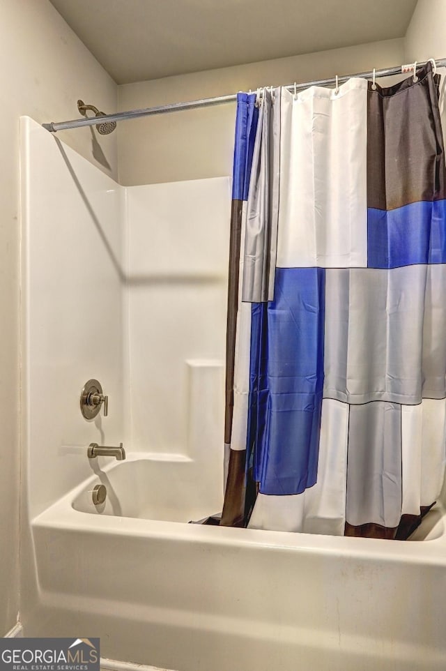 bathroom with shower / bathtub combination with curtain