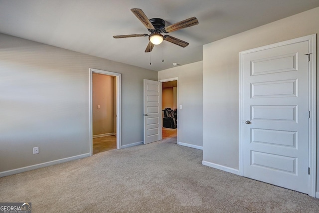 unfurnished bedroom with ceiling fan, carpet flooring, and baseboards