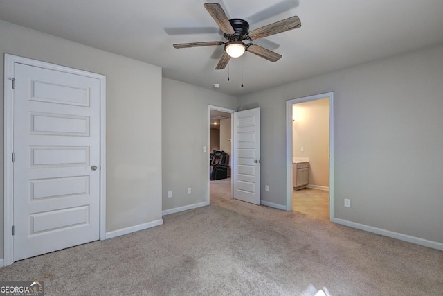 unfurnished bedroom featuring ensuite bath, baseboards, and carpet flooring