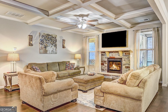 living room featuring dark wood-style floors, beamed ceiling, a fireplace, and visible vents