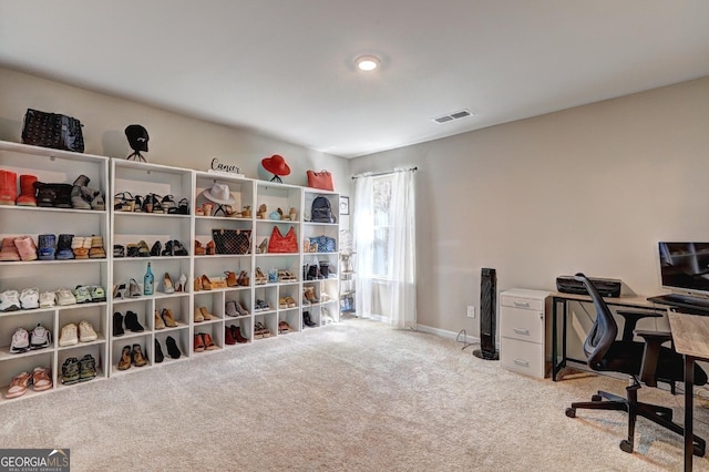 carpeted home office featuring visible vents and baseboards