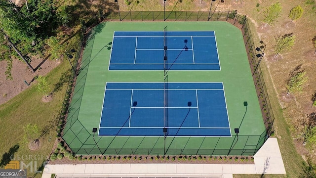 view of tennis court featuring fence