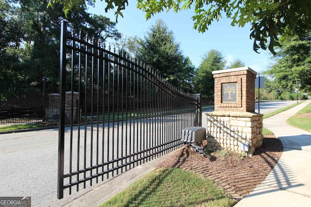 view of gate with fence