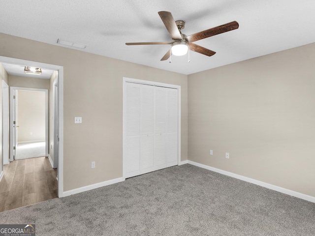 unfurnished bedroom featuring a closet, baseboards, and carpet flooring