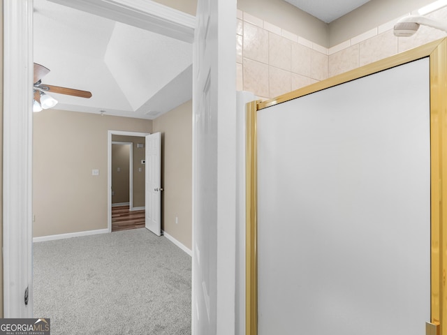 bathroom with a ceiling fan and baseboards