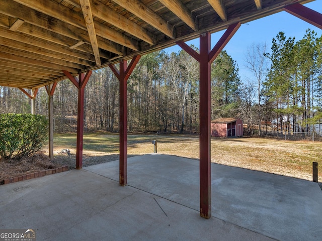 view of patio / terrace with an outdoor structure and a storage shed