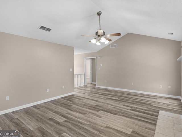 interior space with lofted ceiling, visible vents, and wood finished floors