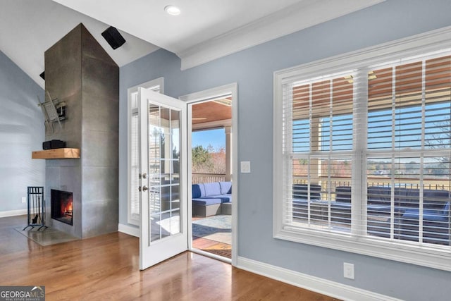 entryway with a fireplace, baseboards, and wood finished floors