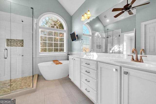 full bathroom with lofted ceiling, a stall shower, double vanity, and a sink