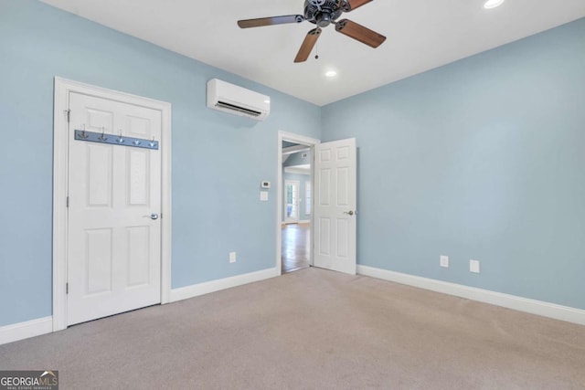 unfurnished bedroom featuring baseboards, carpet flooring, and a wall mounted AC