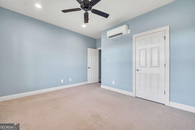 unfurnished bedroom with light carpet, recessed lighting, a wall unit AC, and baseboards