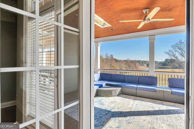 sunroom / solarium featuring ceiling fan and wooden ceiling