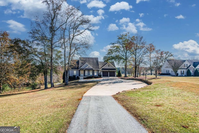 view of front facade with aphalt driveway and a front lawn