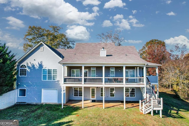 back of house with a patio, stairs, a yard, driveway, and a chimney