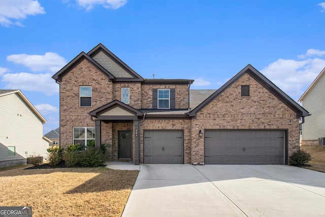 view of front facade with concrete driveway and brick siding