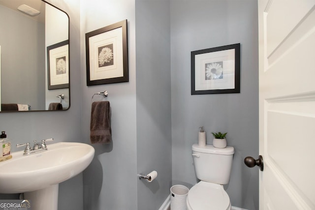 half bath with toilet and a sink