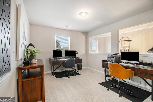 office area featuring baseboards, visible vents, and light colored carpet