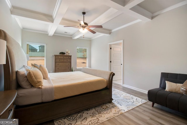 bedroom featuring coffered ceiling, multiple windows, beamed ceiling, and wood finished floors