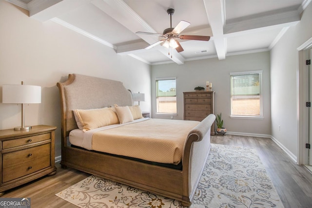 bedroom with coffered ceiling, visible vents, baseboards, beam ceiling, and light wood finished floors