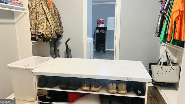 spacious closet with dark wood-type flooring and washing machine and clothes dryer