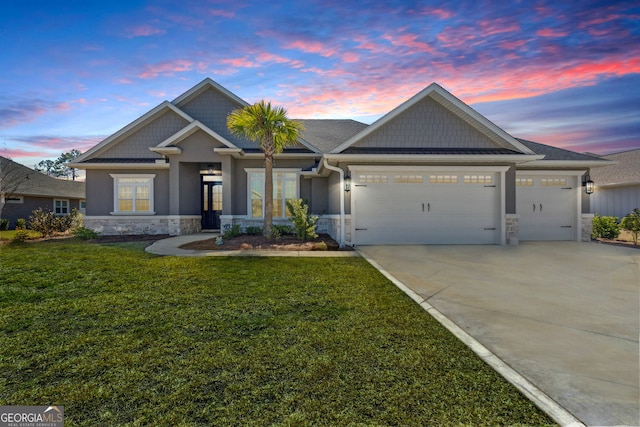 craftsman-style house with an attached garage, driveway, stone siding, a lawn, and stucco siding