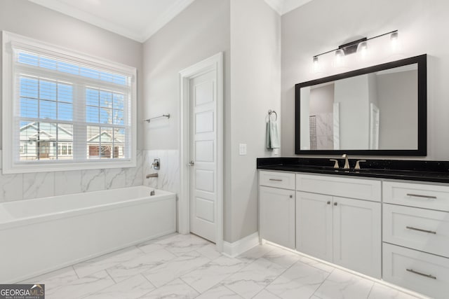 full bath with baseboards, a bathing tub, ornamental molding, marble finish floor, and vanity