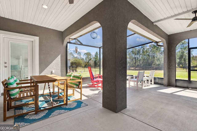 view of patio featuring a lanai and ceiling fan