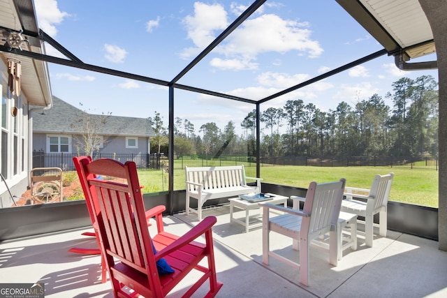 view of patio / terrace featuring glass enclosure, outdoor lounge area, and a fenced backyard