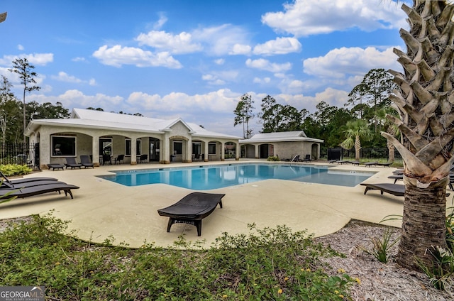 pool featuring a patio and fence