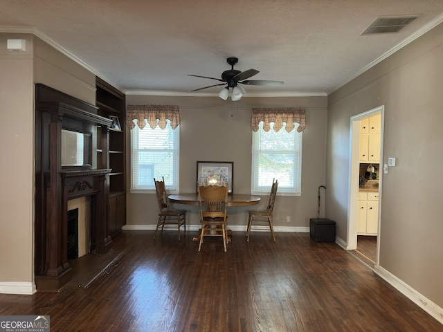 3 Elm St, Porterdale, GA 30014 - dining area with ceiling fan, dark wood finished floors, a fireplace, ornamental molding, and built in shelves