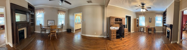 entryway featuring baseboards, a ceiling fan, lofted ceiling, wood finished floors, and a fireplace