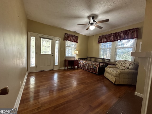 3 Elm St, Porterdale, GA 30014 - living room with wood finished floors, a ceiling fan, healthy amount of natural light, and a textured ceiling