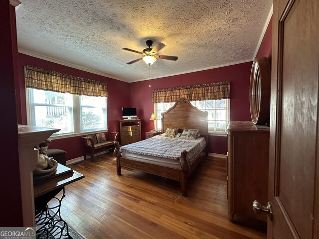 3 Elm St, Porterdale, GA 30014 - bedroom featuring a textured ceiling, wood finished floors, crown molding, and a ceiling fan