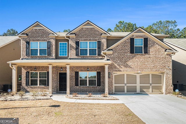 traditional-style home with cooling unit, concrete driveway, and brick siding