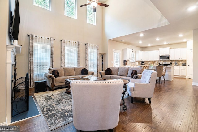 living area featuring plenty of natural light, dark wood finished floors, and recessed lighting