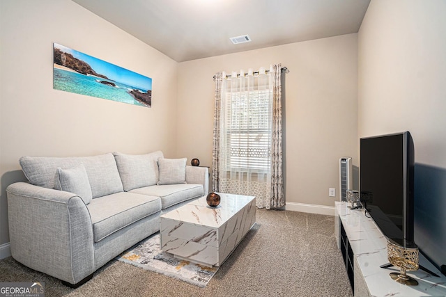 carpeted living area featuring visible vents and baseboards