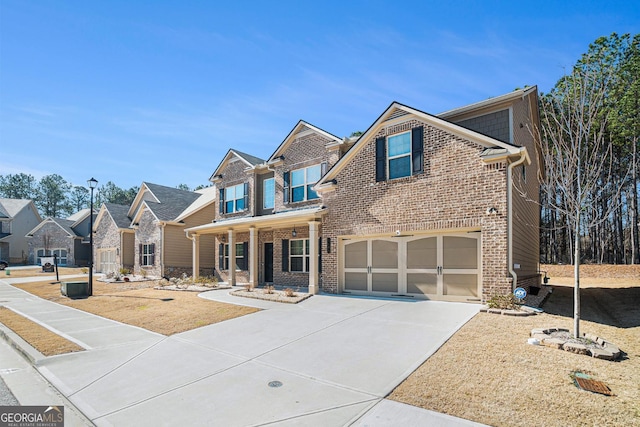 view of front facade featuring concrete driveway, brick siding, an attached garage, and covered porch